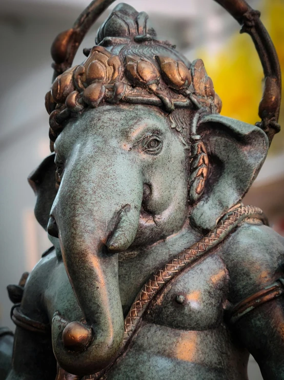 bronze sculpture of an indian elephant with a crown on his head