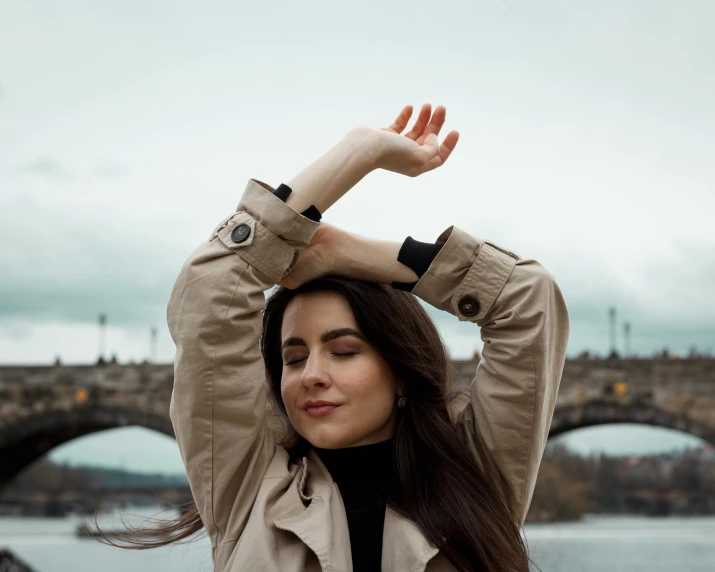 the woman is practicing yoga outdoors in front of the river