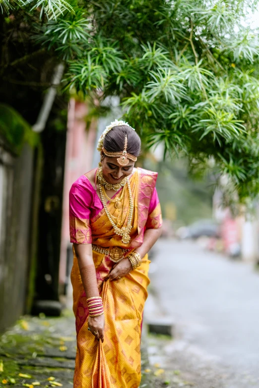 an indian woman in her colorful and beautiful sari looks down on her belted skirt