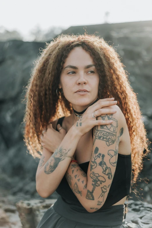 the woman with tattoos poses for a portrait