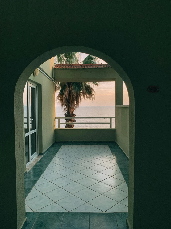 an arch leading to the ocean and a balcony area