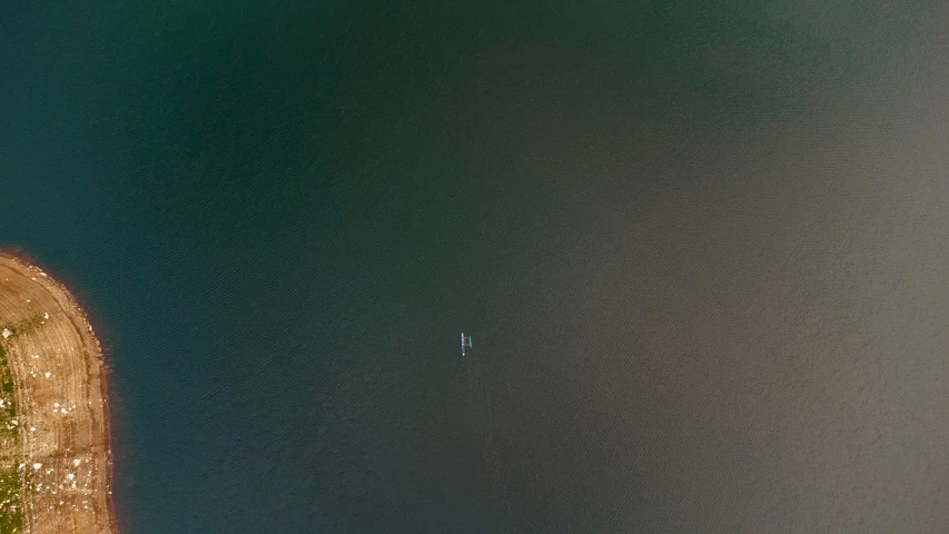 an airplane that is flying over water and land