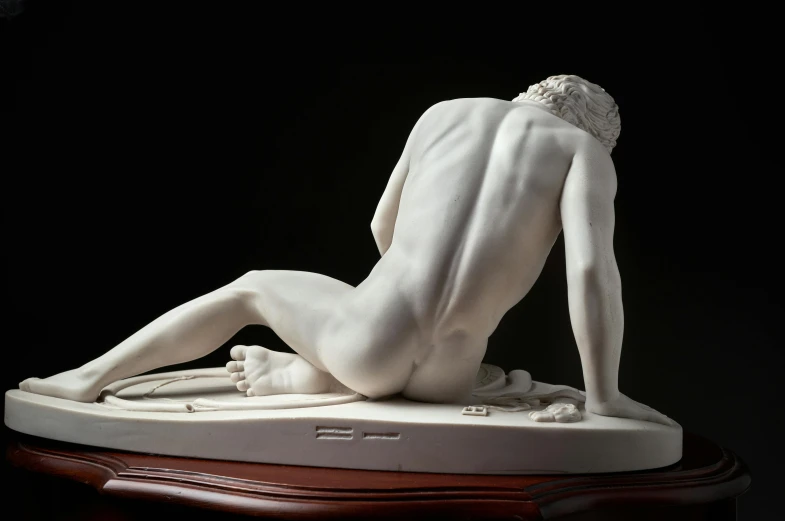 a white marble sculpture of a kneeling woman