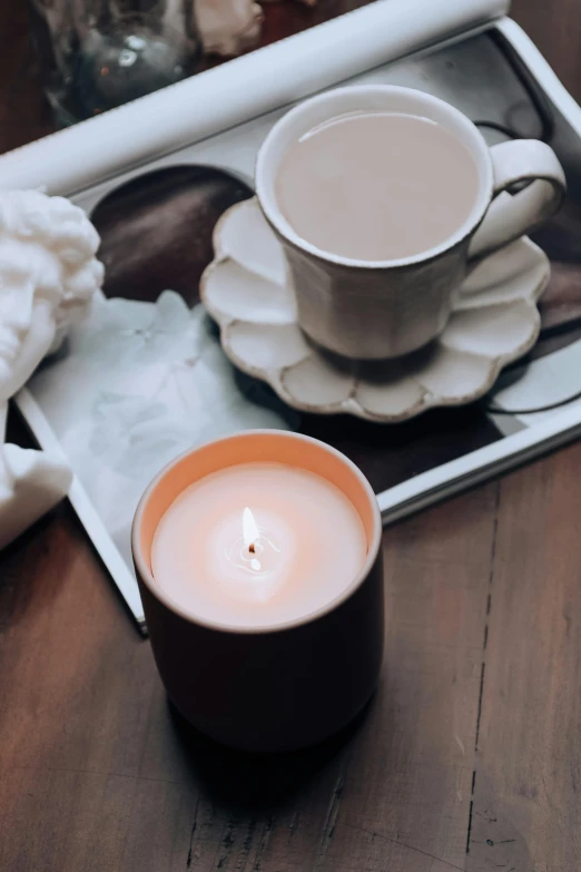 a lit candle and some food in a box