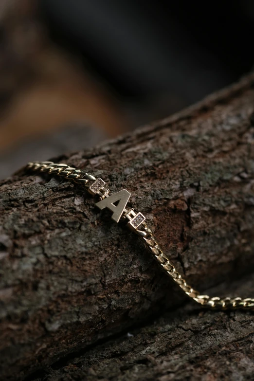 a chain celet with a silver cross on it