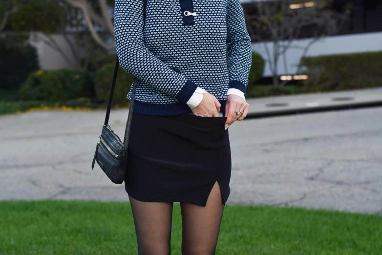 a woman in blue and black wearing a skirt