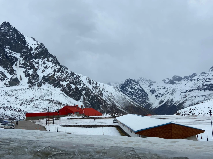 several buildings, mountains, and snow with some buildings in the background