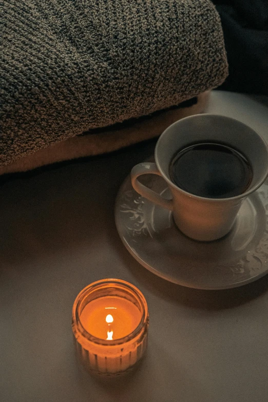 a tea cup with candle sitting on the floor