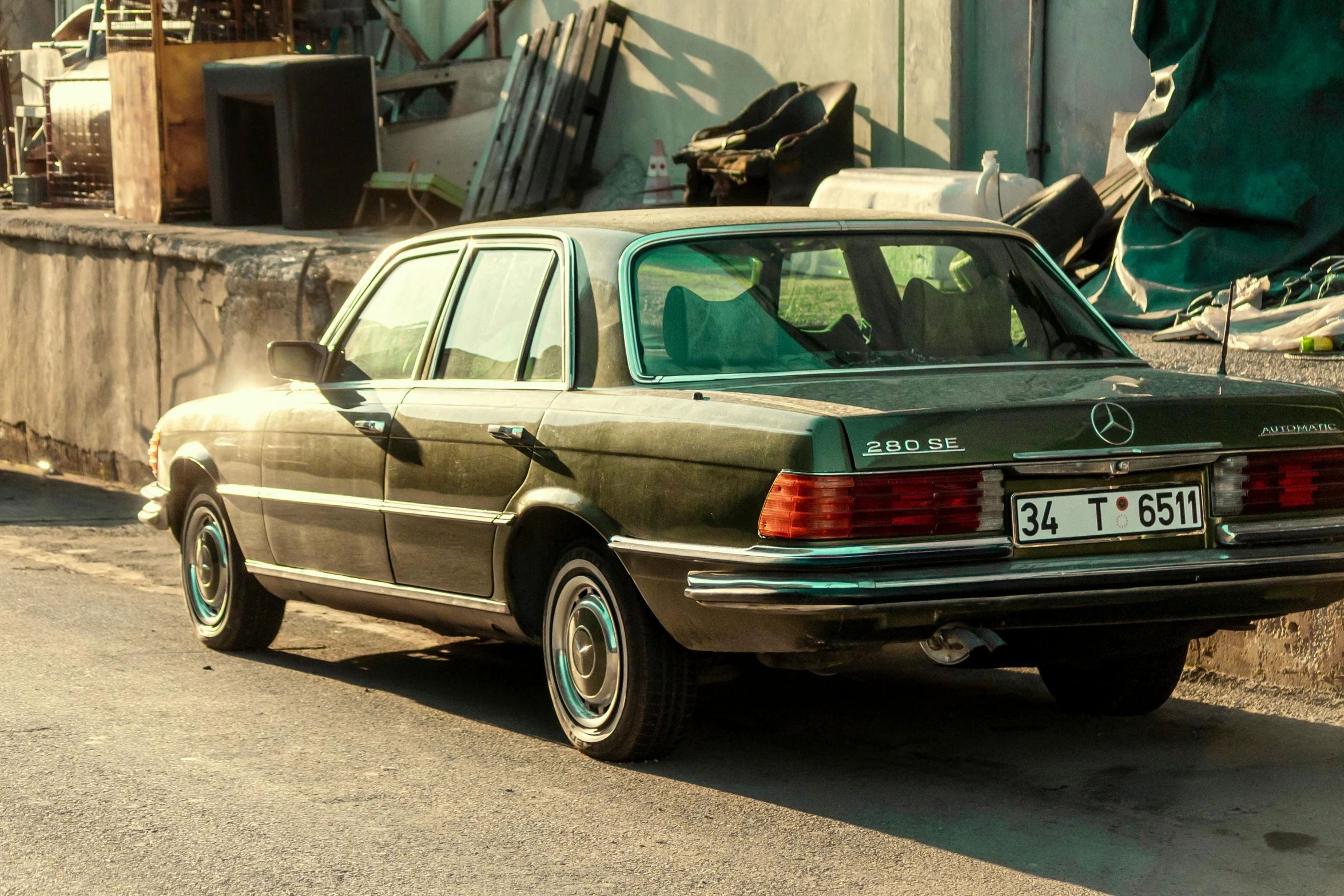 an old mercedes sitting parked on the street