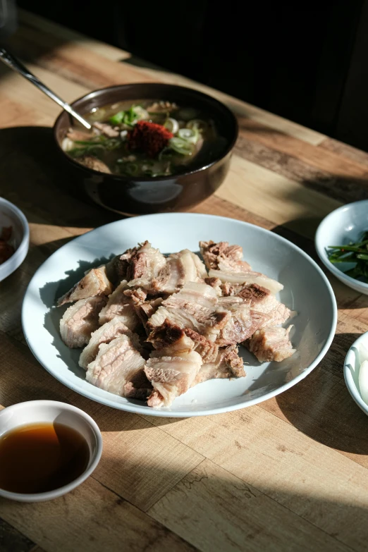 food in bowls, chop sticks and green beans are displayed