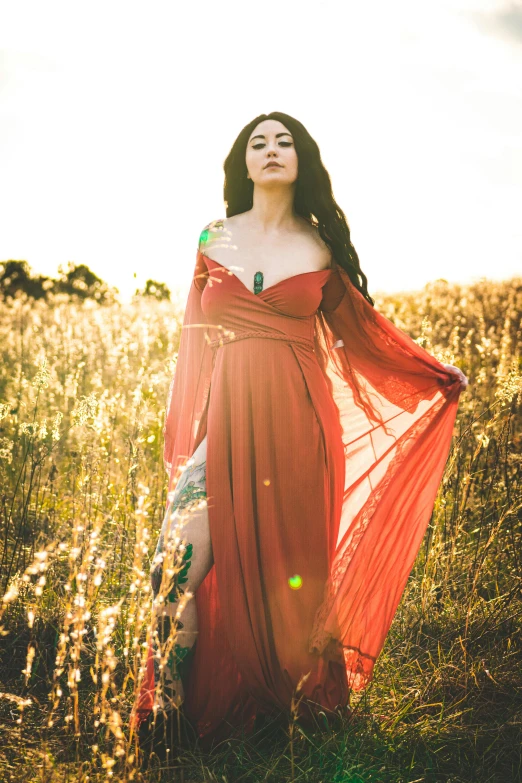 a woman in a dress standing outside