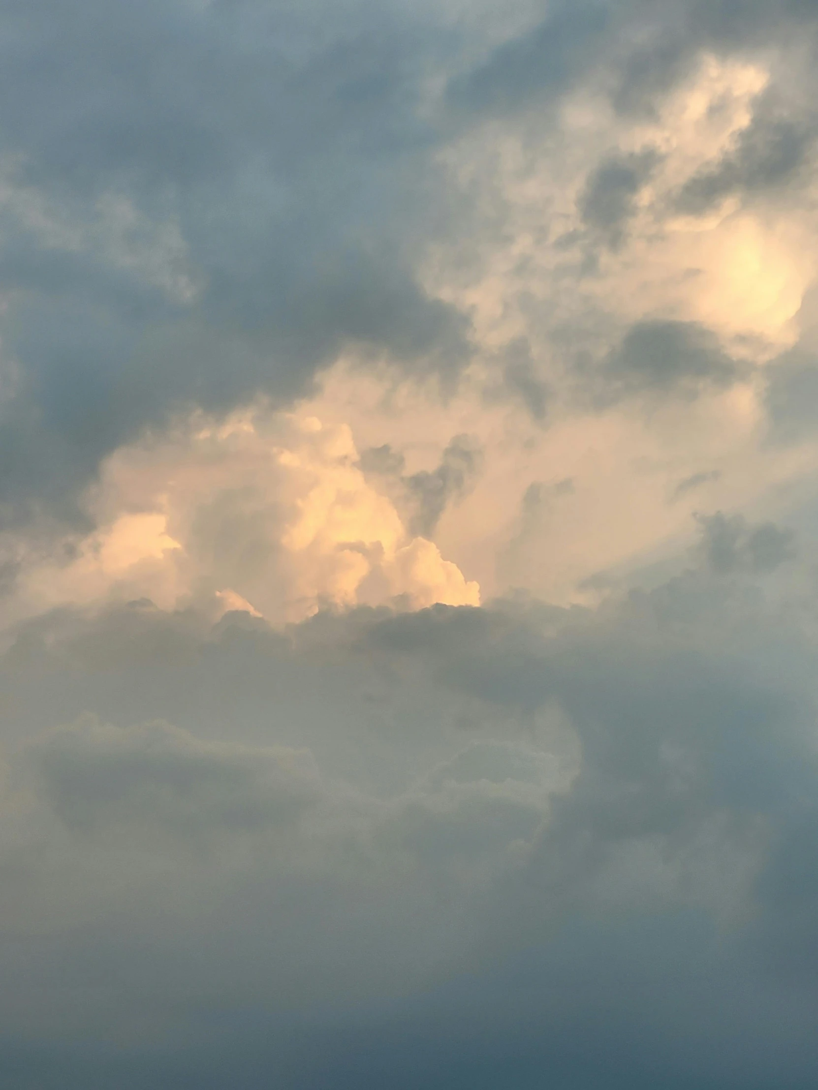 the sky is covered with clouds and some birds