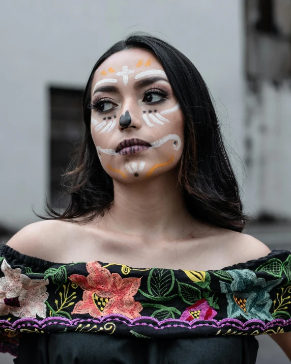 a girl with face paint stands on the street