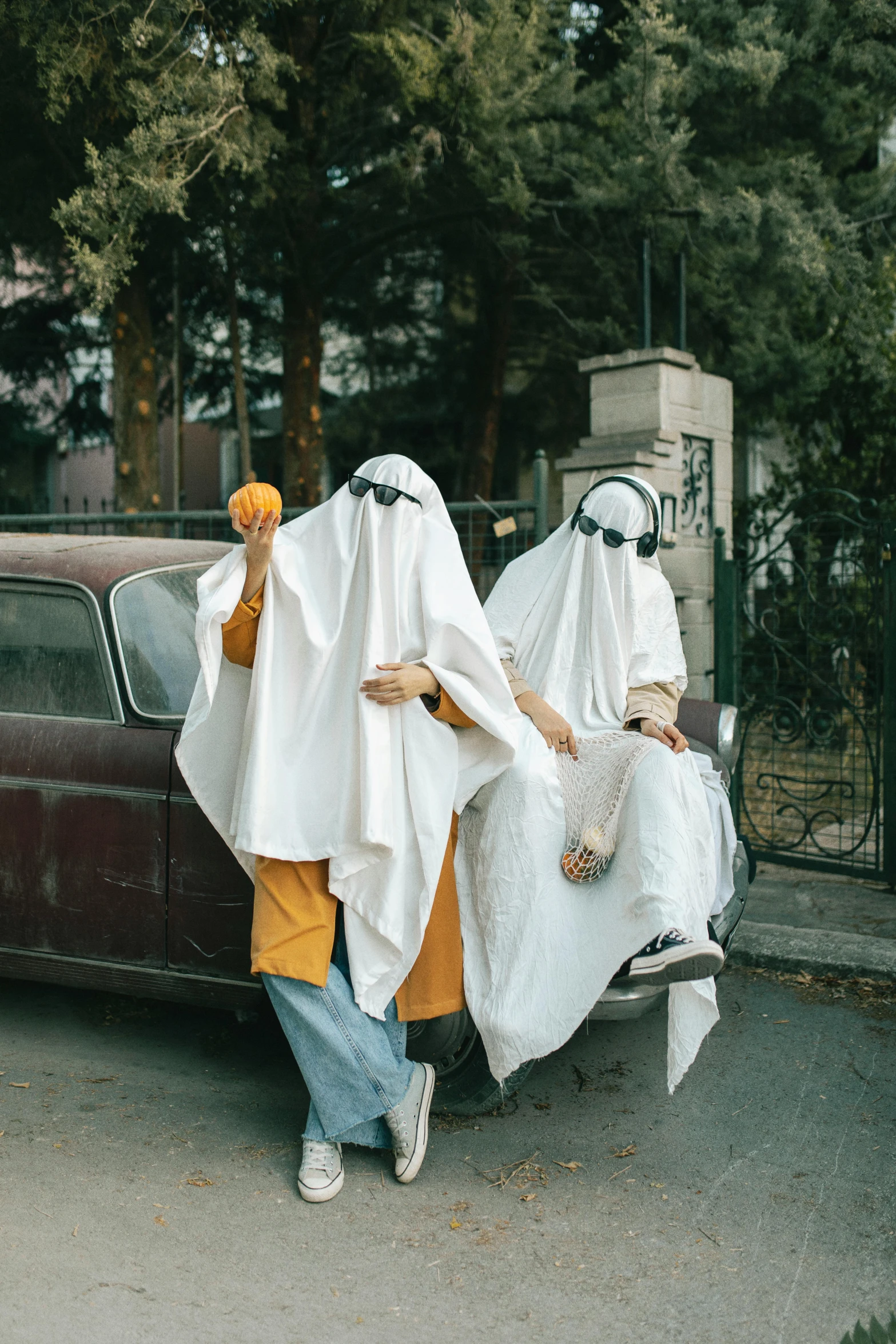 two people in white robes are riding on a truck