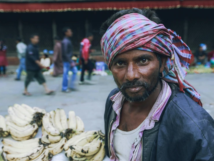 man with headband and lots of bananas