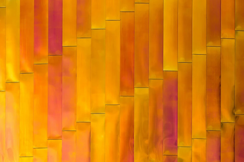 this yellow and orange structure has been made with strips of wood