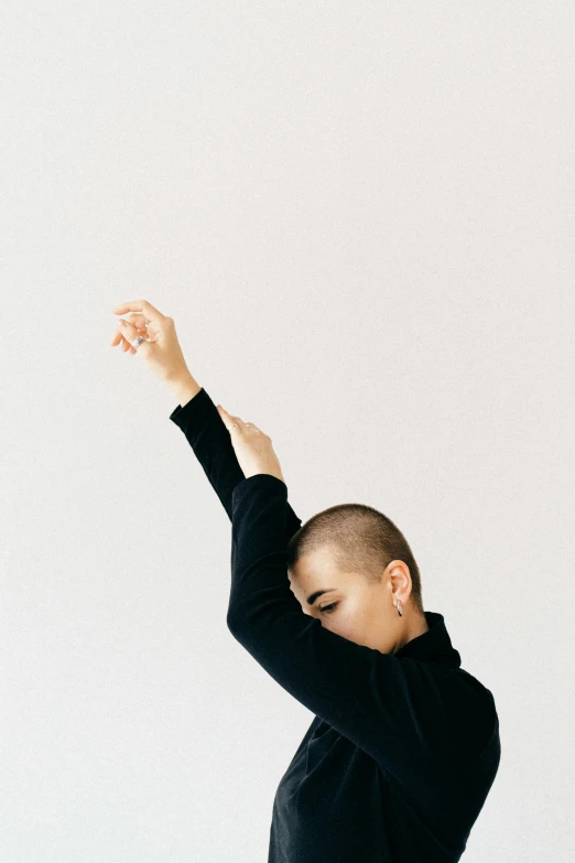 a young man with dark hair and black sweatshirt dancing