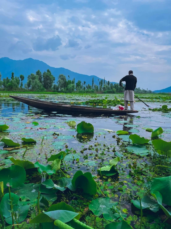 a man stands in the water beside the boat