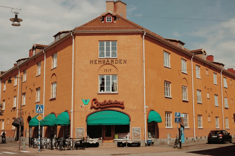 a tall brown building sitting next to a green awning