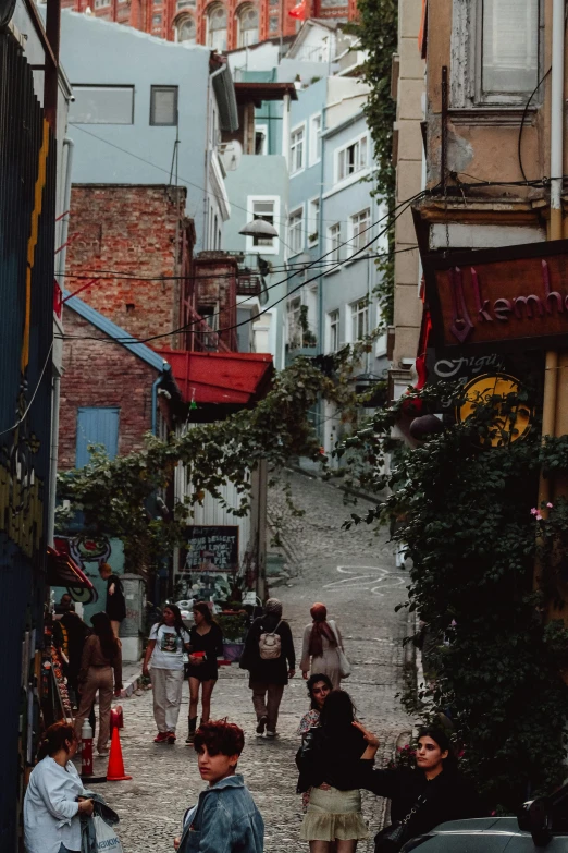 a group of people walking down a cobblestone street