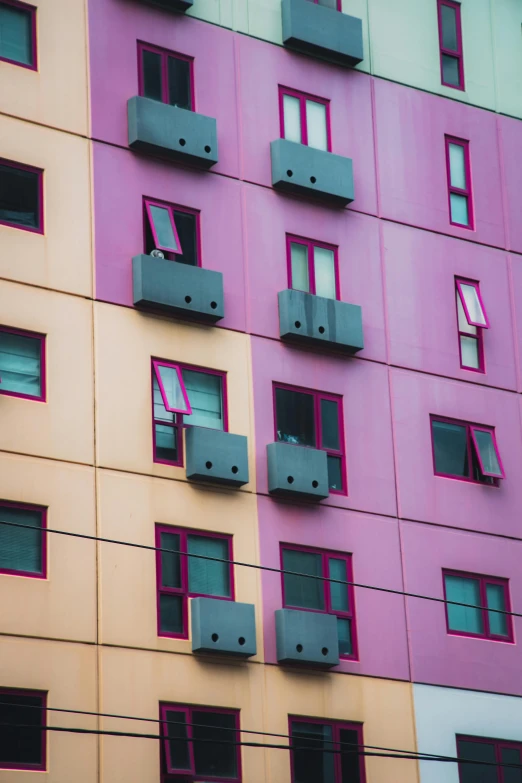 multicolored building with several balconies and a clock