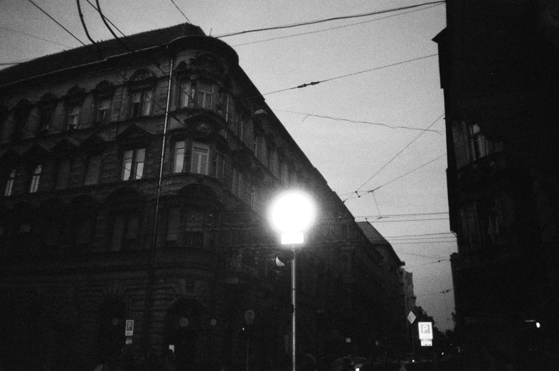 black and white image of a building lit by street light