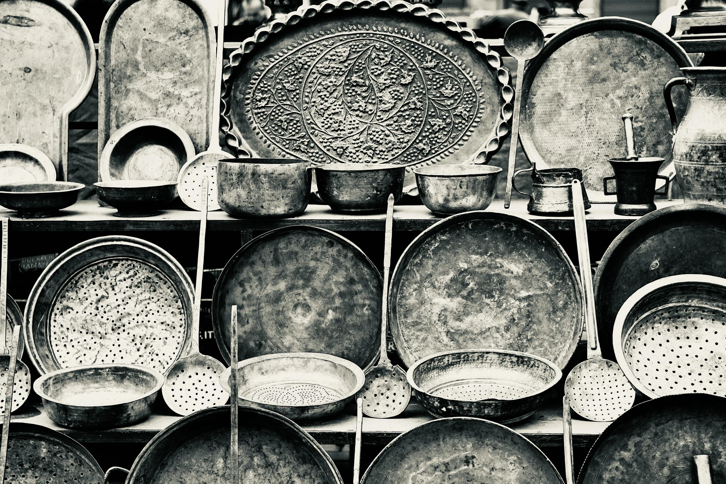 many metal dishes on display with plates and cups