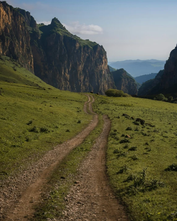 the trail winds through the green mountains