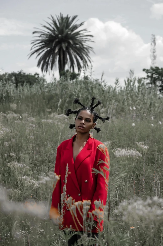 a girl in a red dress in tall grass