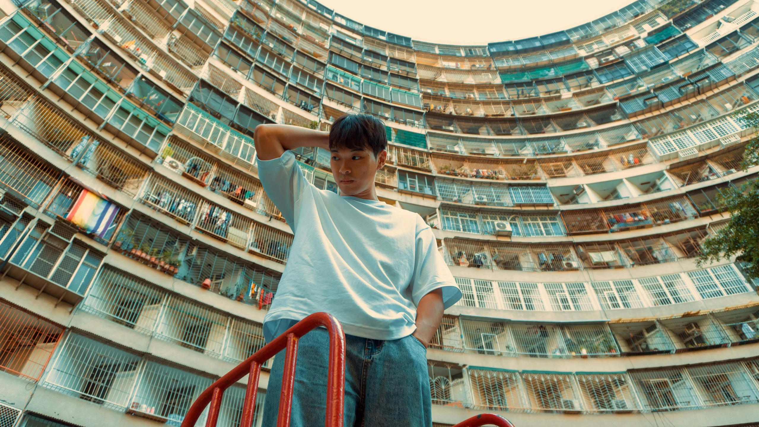 there is a man standing in front of a very tall building