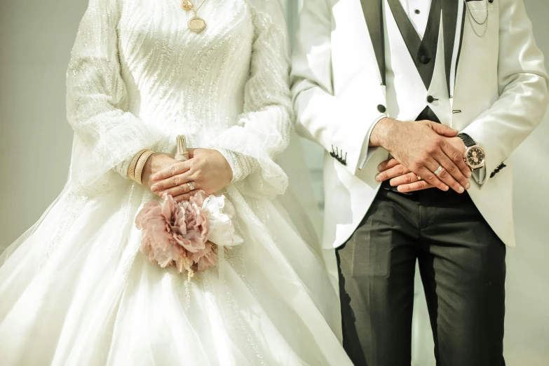 two people in formal wear, holding hands with one another