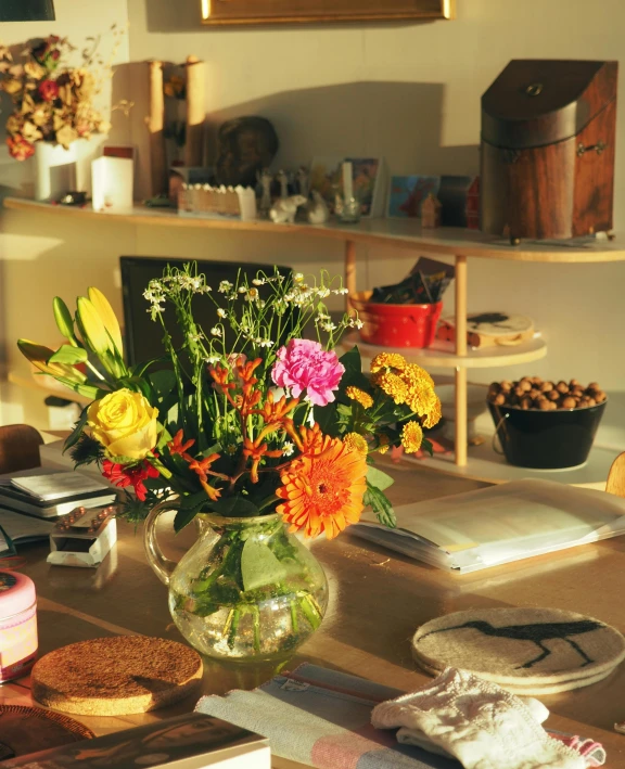 vase with lots of colorful flowers sitting on a table