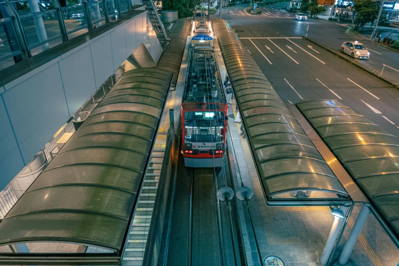 a train in the middle of a train station, with its lights on