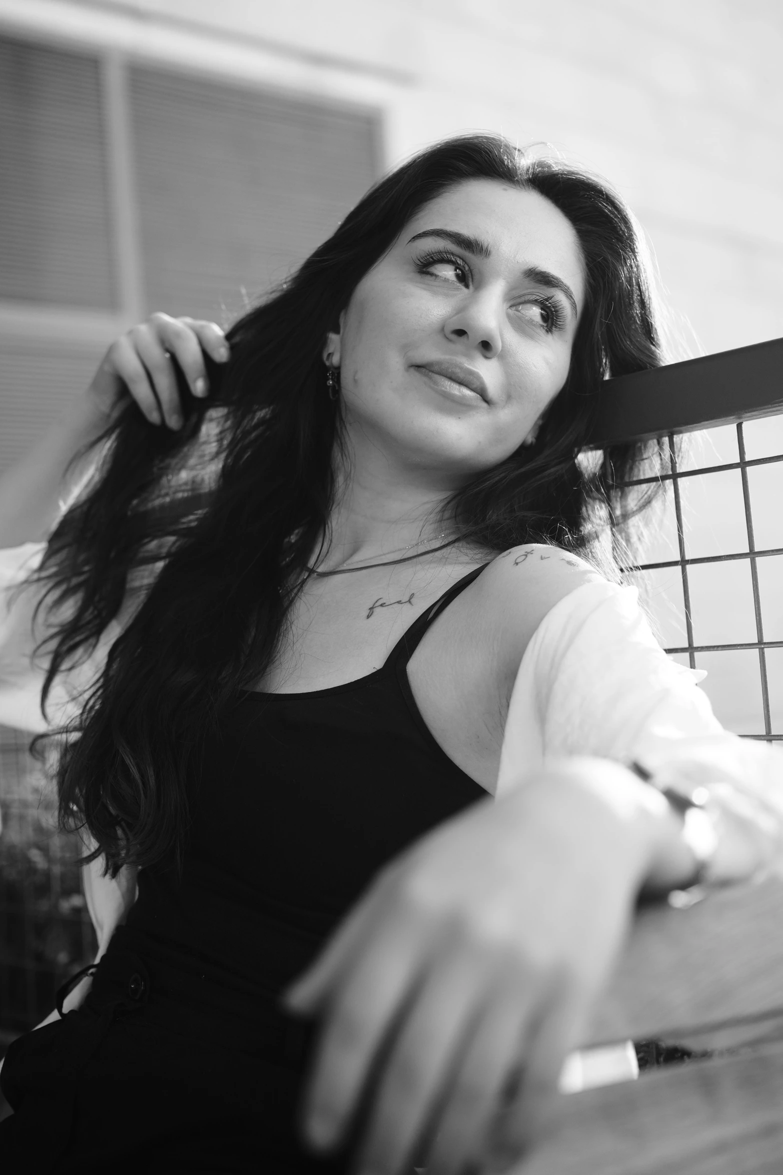 a girl with black hair, wearing an arm ce, sits on a porch holding a basket