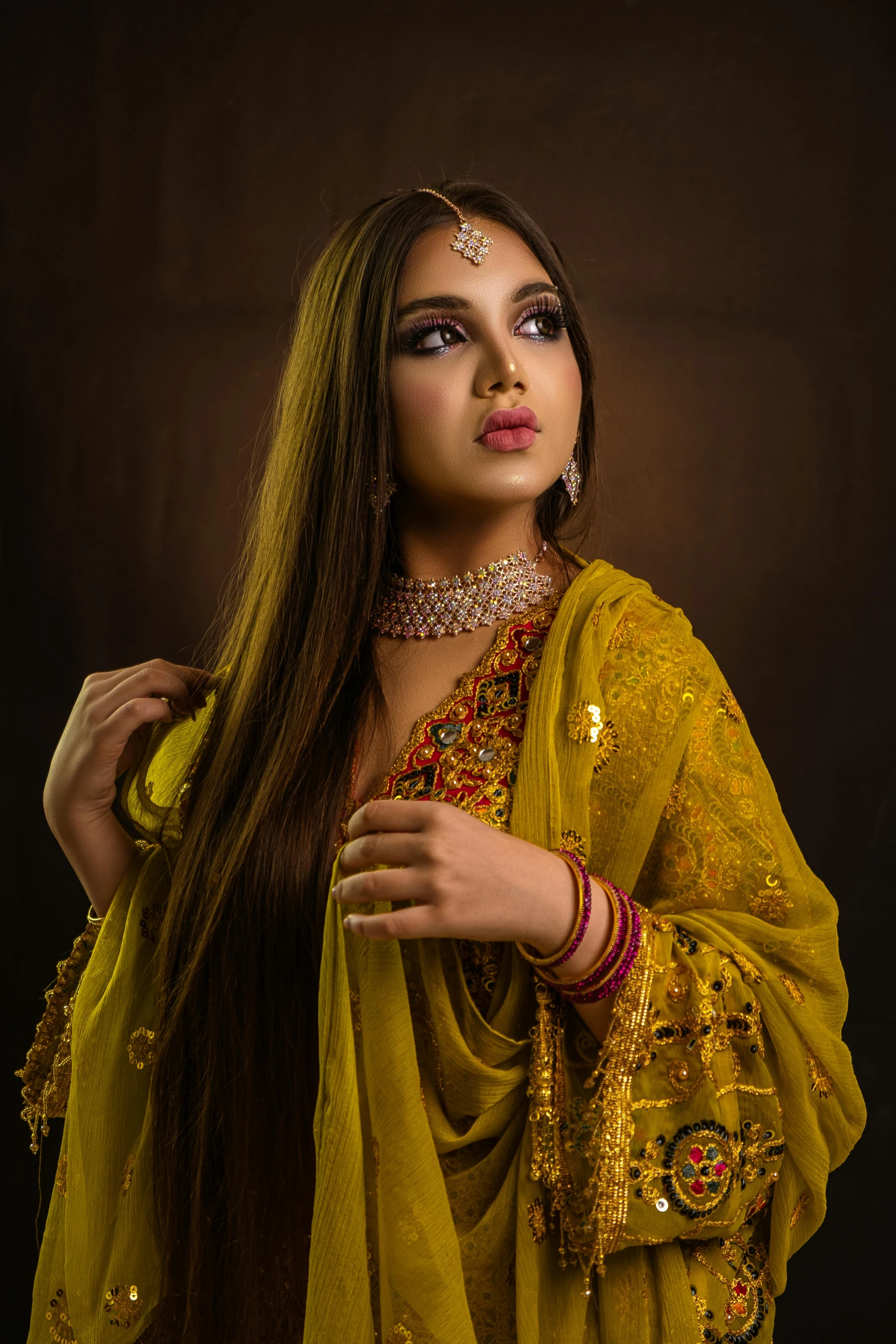 a woman in yellow clothes standing with long hair