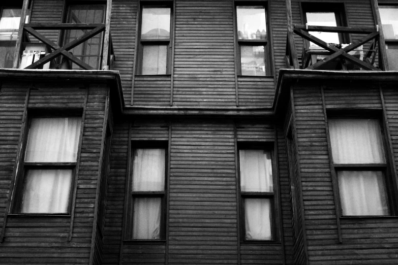 an image of several windows and two fire escapes