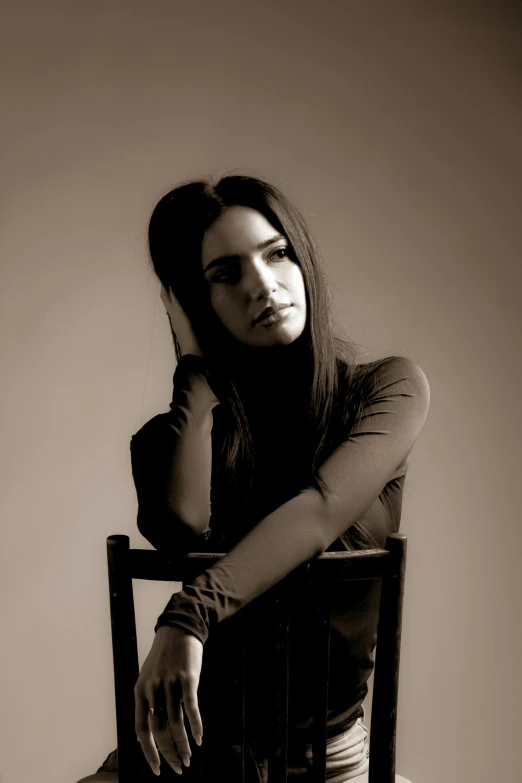 black and white po of a woman sitting in a chair