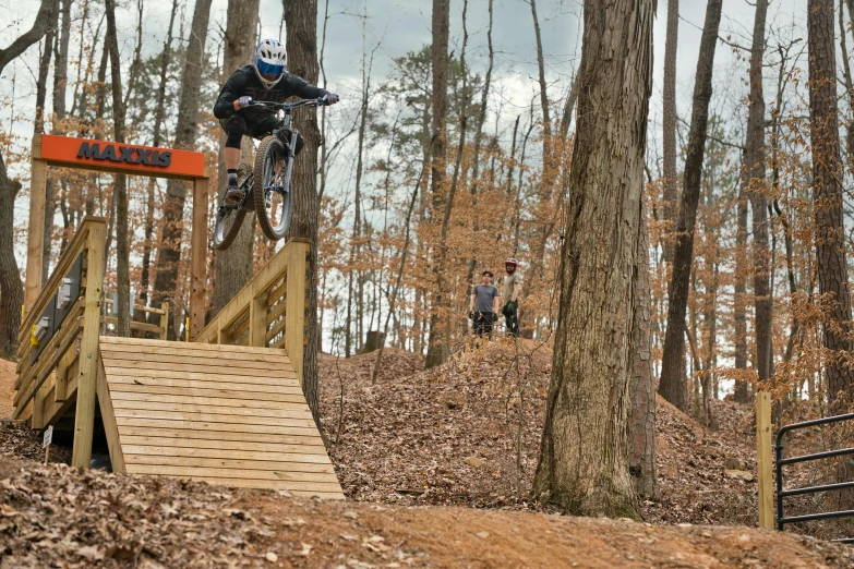 a person flying through the air while riding a bike