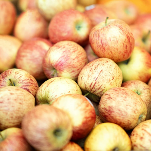 many red apples sitting together on top of each other