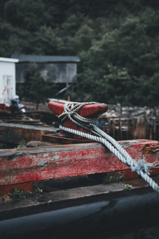 an old rusted boat is parked in a yard