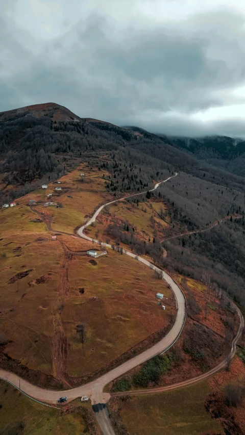 an aerial view of the roadway leading to the top of the mountain