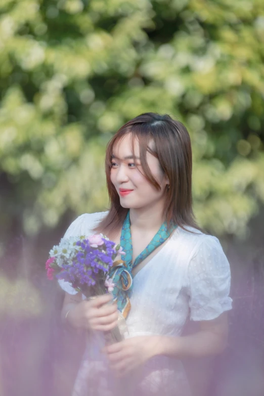 a woman holding flowers with a green background