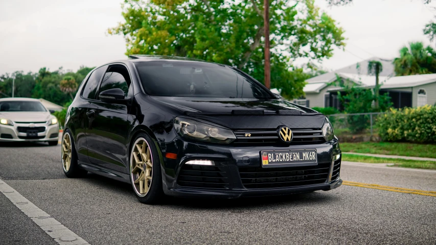 the volkswagen golf is shown parked on the side of a road