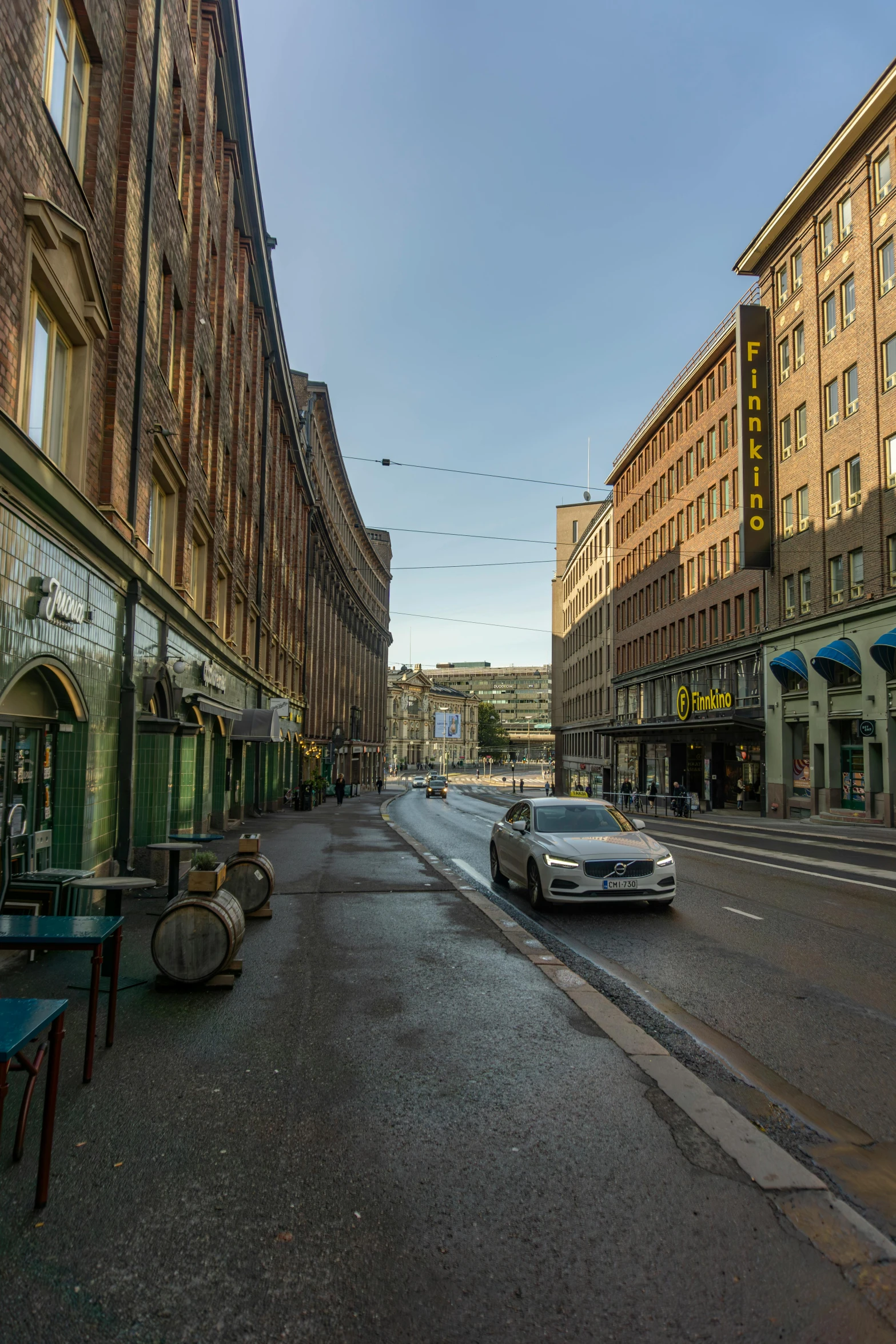 two cars are driving through an empty city street