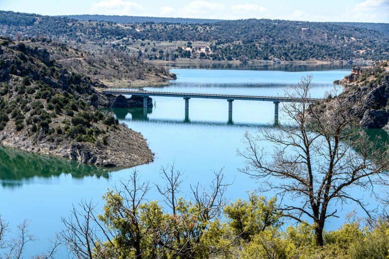 a bridge is over the blue waters in an area