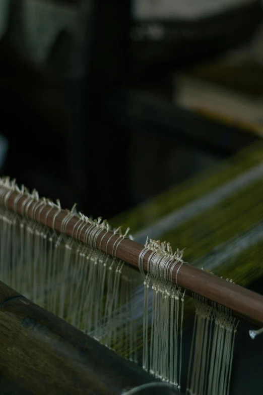 the warper has long wooden pieces of thread on it