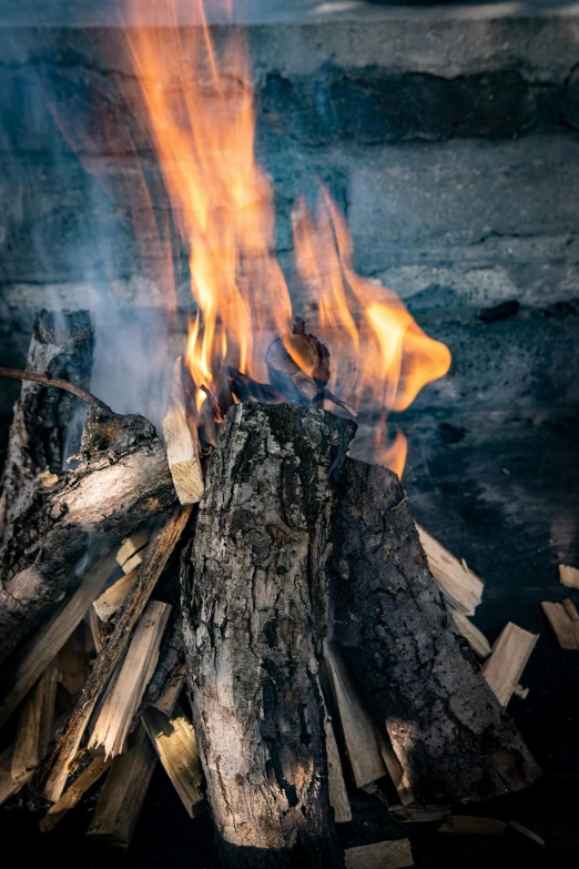 a pile of firewood with many flames coming out