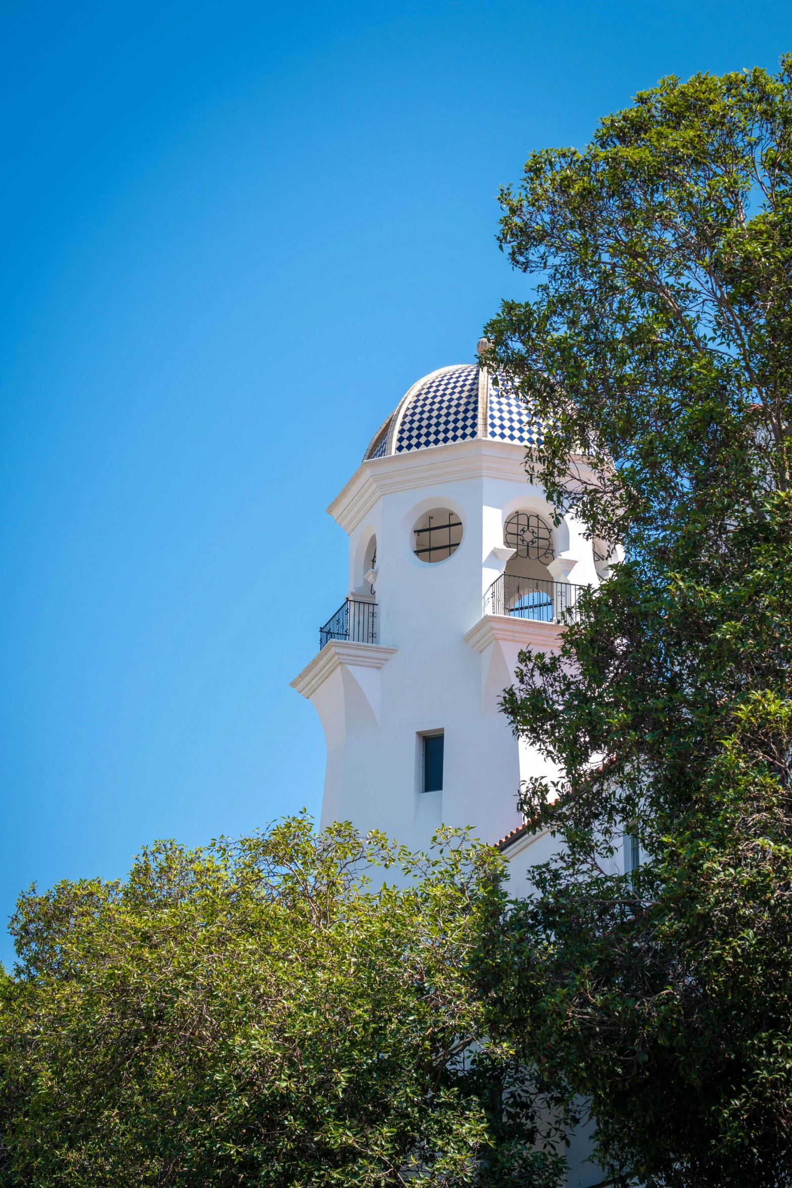 a white and blue building with trees around it