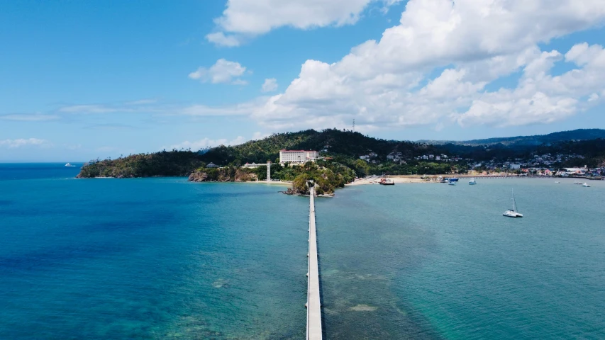 a long white road stretches out into the ocean