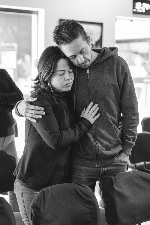 a woman hugging a man at an airport